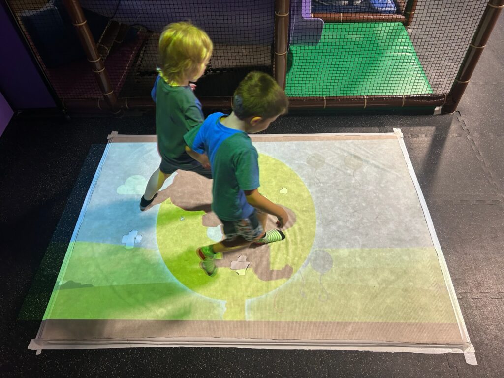 Kids playing on projection game